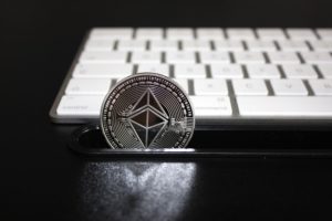moneta ethereum przy białej klawiaturze